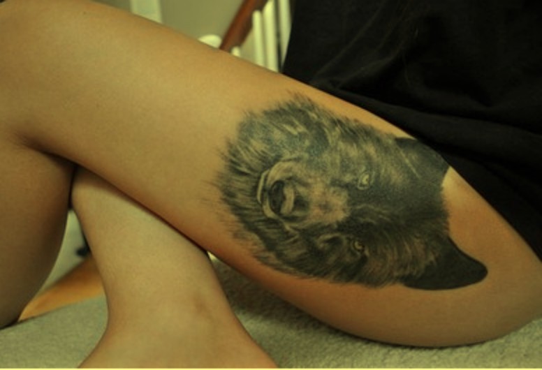 wilk tatuaż na udzie
