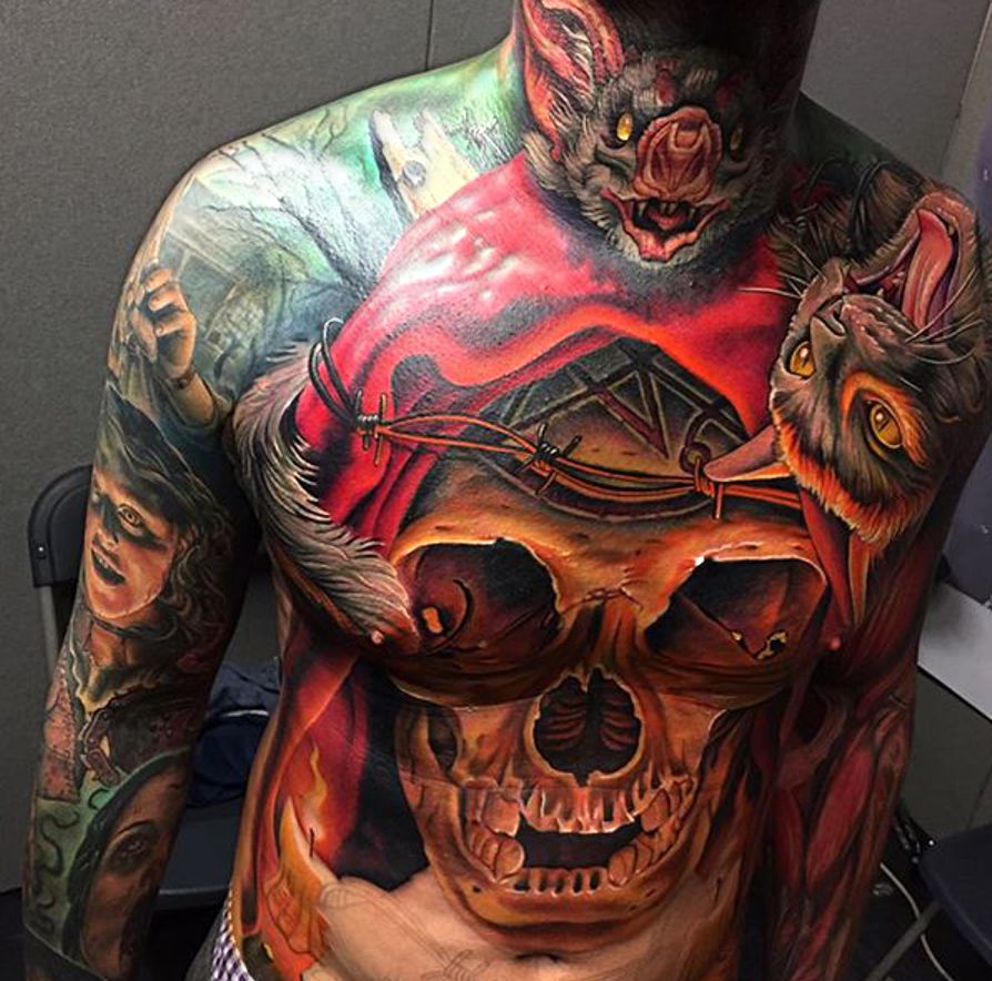 skull and bats tattoo on chest