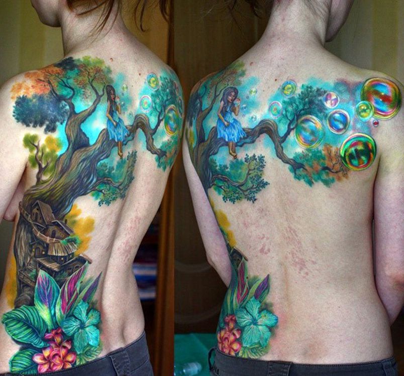 girl on tree amazing tattoo