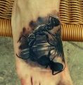 ant tattoo on the foot