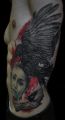 crow face ribs tattoos