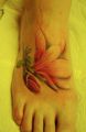 red flower foot tattoo