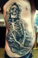 skeleton tattoo on the ribs