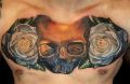 white roses and skull tattoo on chest