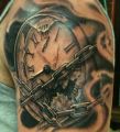 clock and chain tattoo on arm