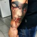demon face tattoo on arm