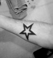 black star tattoo on hand