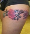 roses tattoo on the thigh