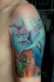 delfiny tatuaże na ramieniu