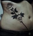 rose and small skull tattoo