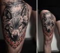 wolf head on leg tattoo