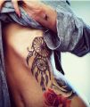 dreamcatcher on ribs tattoos