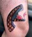 snake head tattoo on leg