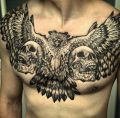 hawk and skulls tattoo on chest
