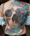 white skull and flowers tattoos on back