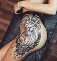 lew tatuaż na biodrze kobiecym