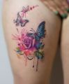 rose and butterfly tattoo on leg