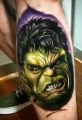Hulk face tattoo on leg